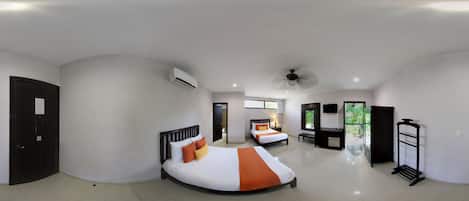 A hotel room with two beds, a ceiling fan, an air conditioning unit, a TV, and a balcony with a view of greenery.