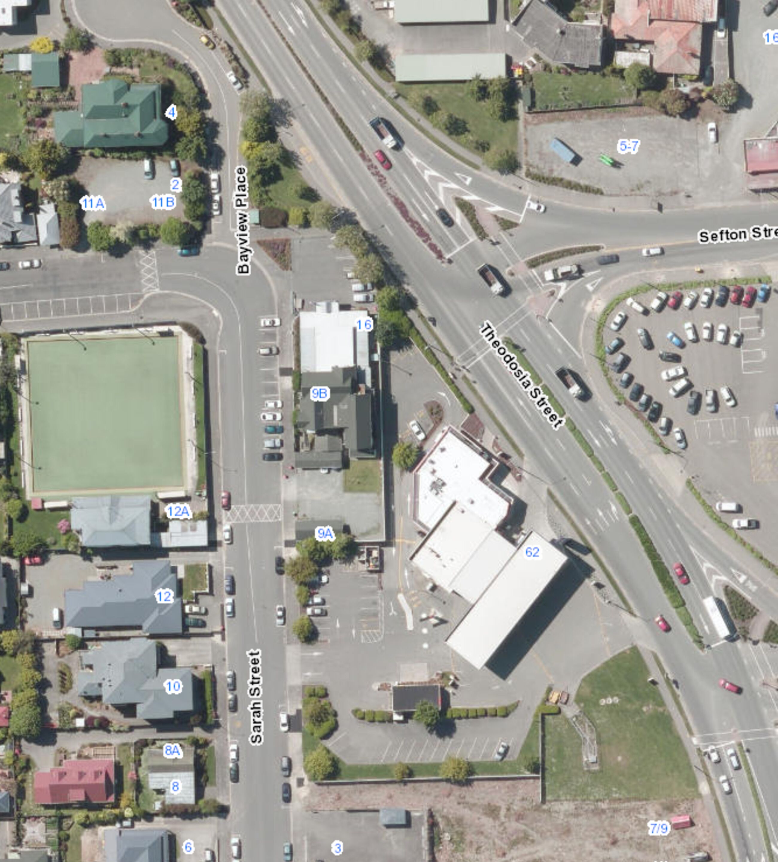 An aerial view of a commercial area with a large building labeled 62, adjacent to a road marked 9A.