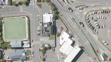 An aerial view of a commercial area with a large building labeled 62, adjacent to a road marked 9A.