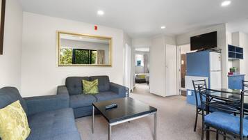 Two Bedroom Suite | Living area | 40-inch flat-screen TV with satellite channels, TV
