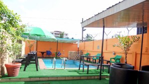 A backyard with a pool, green artificial turf, and outdoor furniture. - Peerage Retreat and Resort (Lagos)