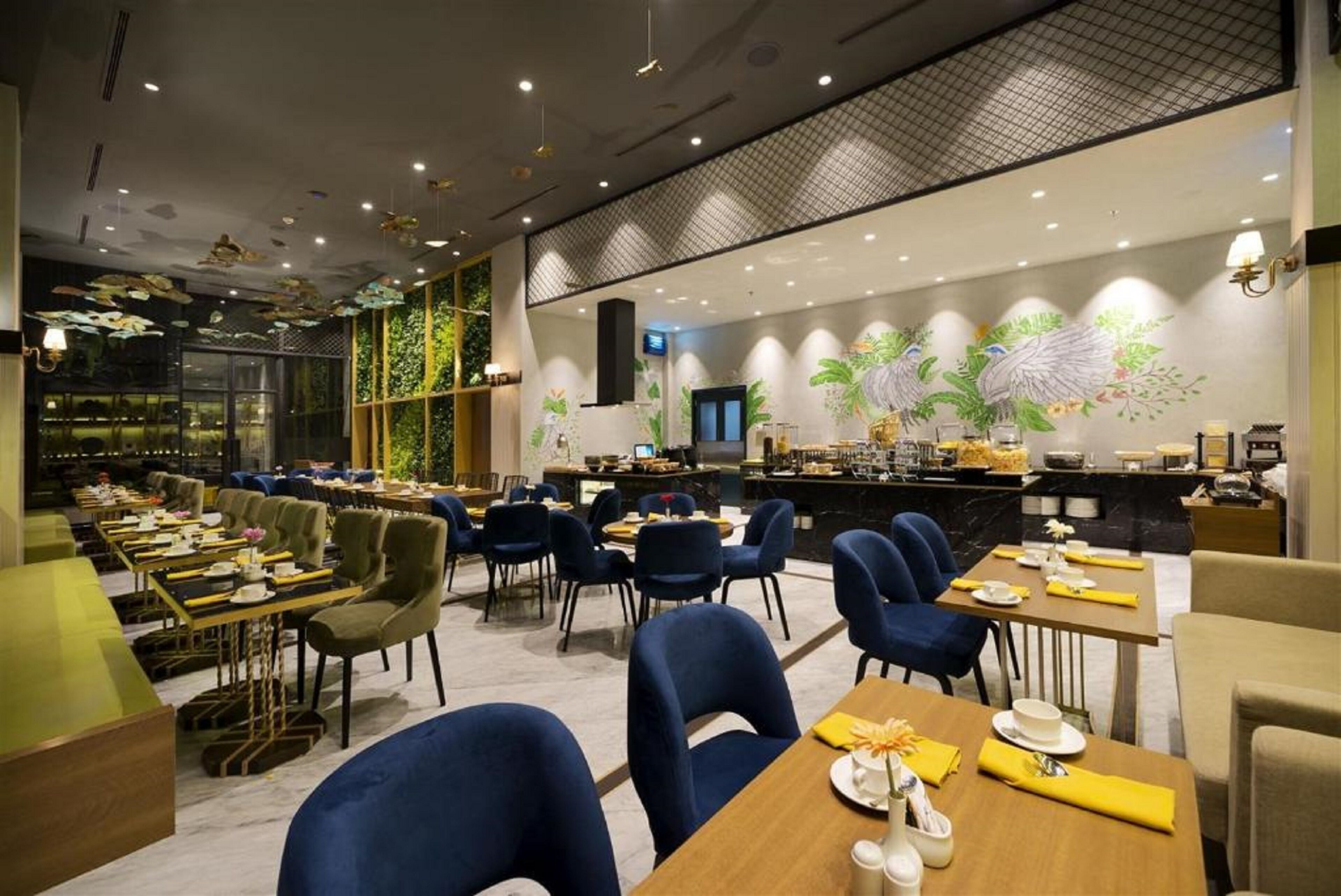 A modern restaurant with a variety of seating options, including tables and chairs, and a bar area with a counter.