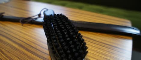 A black computer mouse with a textured surface on a wooden table.