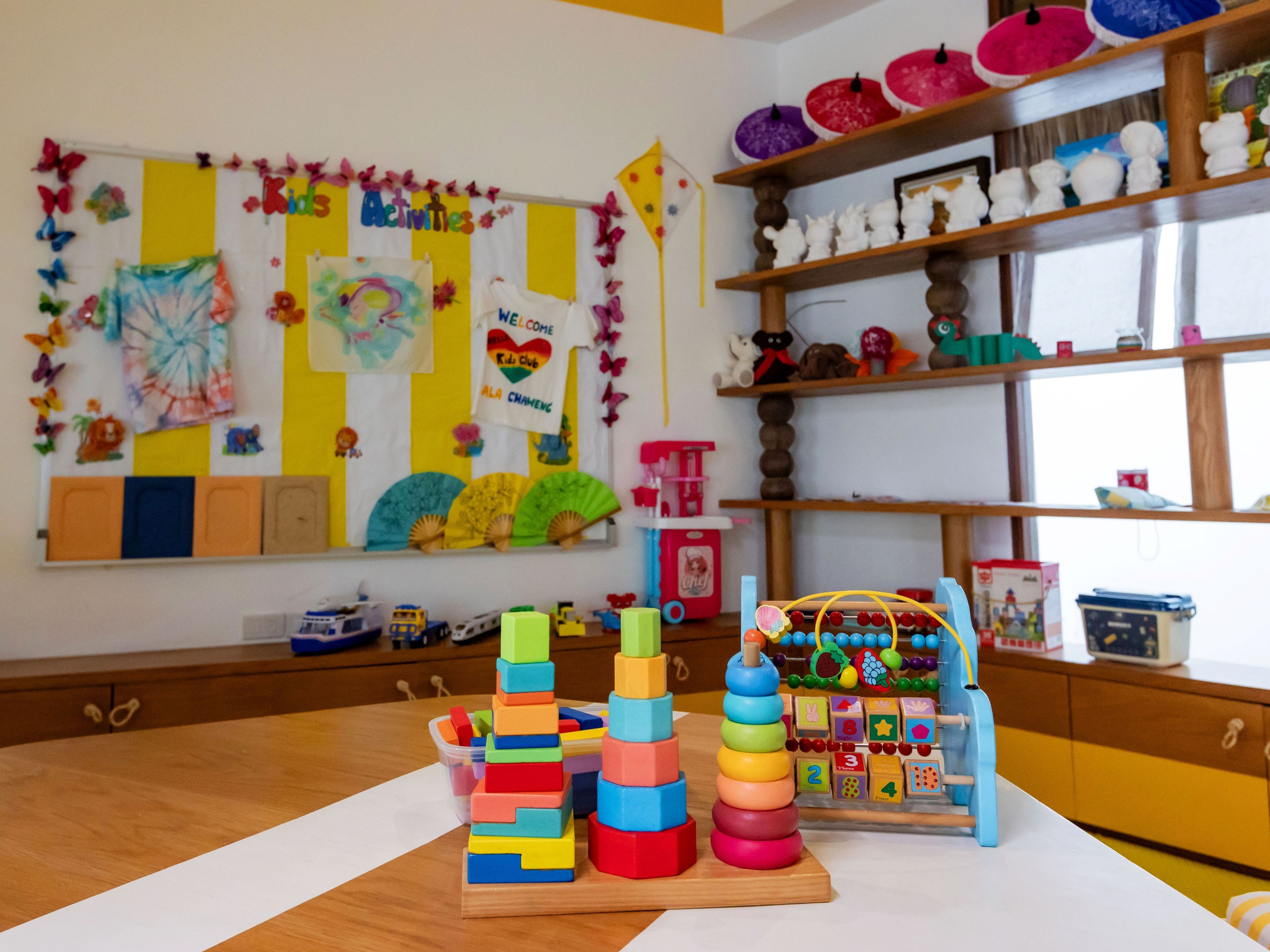 A children's play area with colorful toys and educational decorations.