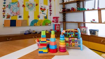 A children's play area with colorful toys and educational decorations.