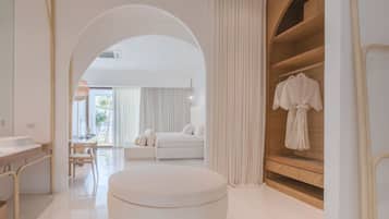 A modern bathroom with a round bathtub, a vanity with a mirror, and a shower area.
