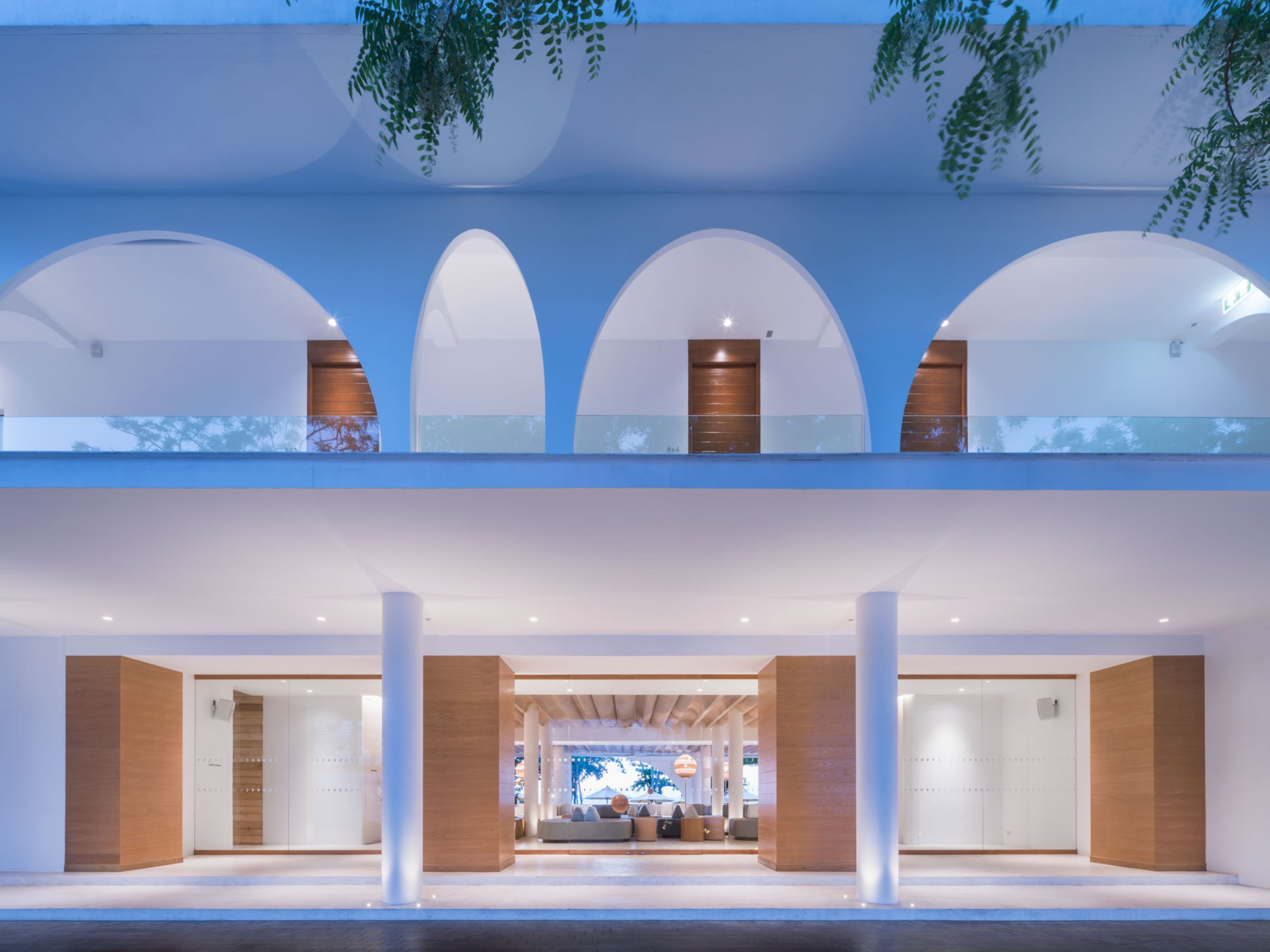 A modern building with a central atrium, multiple levels, and a reception area with seating.