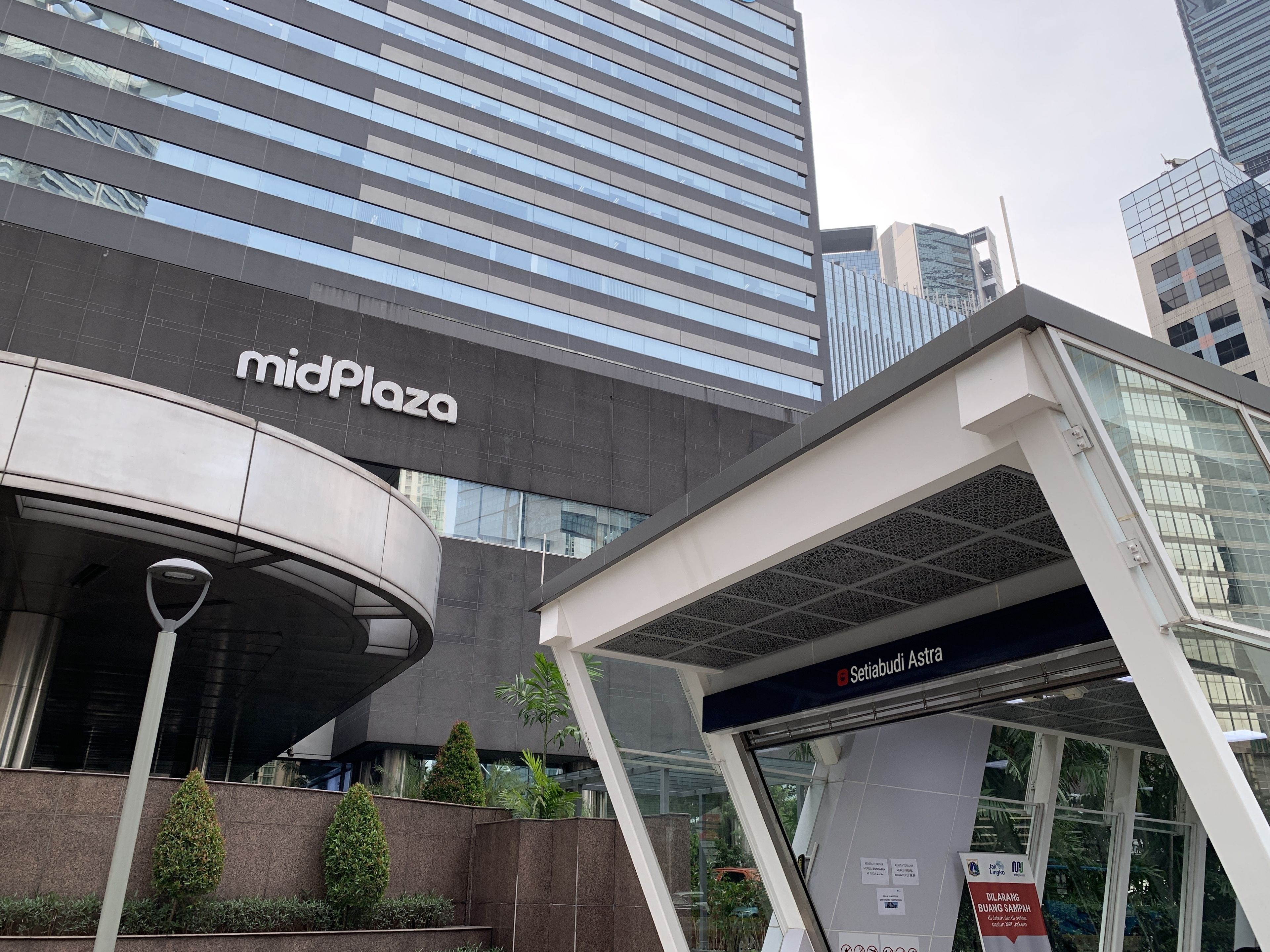 A modern building with a 'midPlaza' sign, a covered entrance, and a sign for 'Setiabudi Astra'.