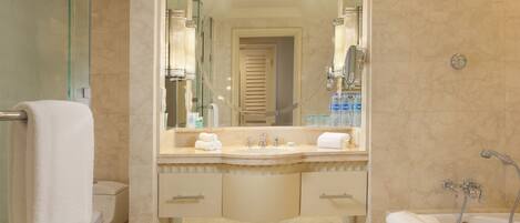 A modern bathroom with a glass-enclosed shower, a double sink vanity with a mirror, and a bathtub.