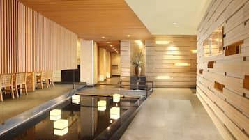 Welcome to our lobby, featuring a long reception desk, comfortable seating area and a soothing water feature.