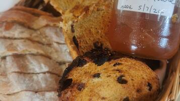 A basket containing various breads and a jar labeled "Orange Marmalade."