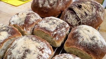 A variety of breads on a rack.