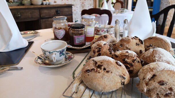 A table with pastries, a teapot, and jars of jam. - Brampton Dales Farm B&B (Gainsborough)