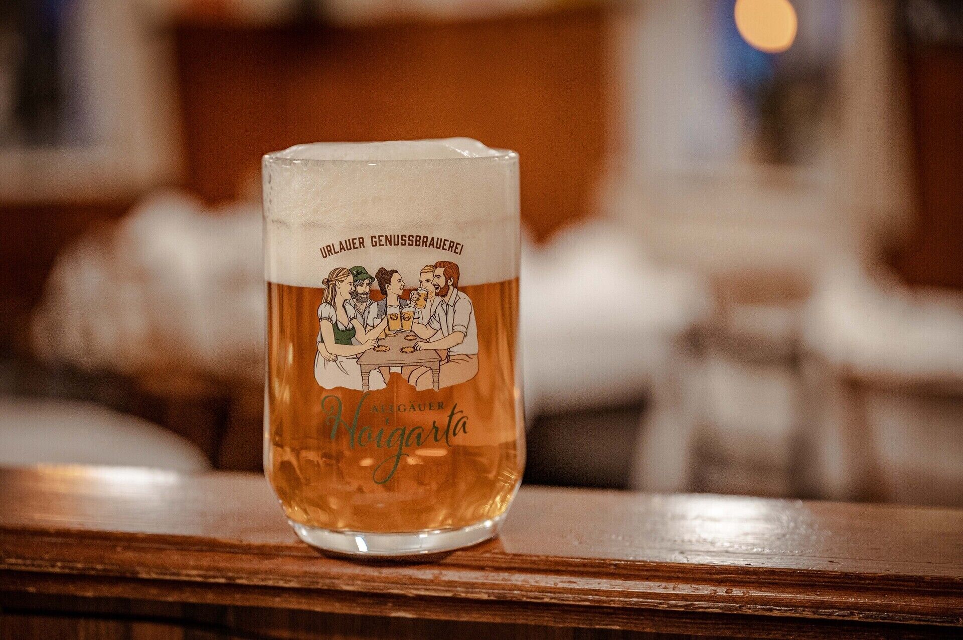A glass of beer with a label featuring a group of people and text.