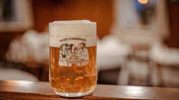 A glass of beer with a label featuring a group of people and text.