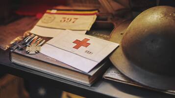 A collection of medals, a Canadian flag, and a helmet on a table.