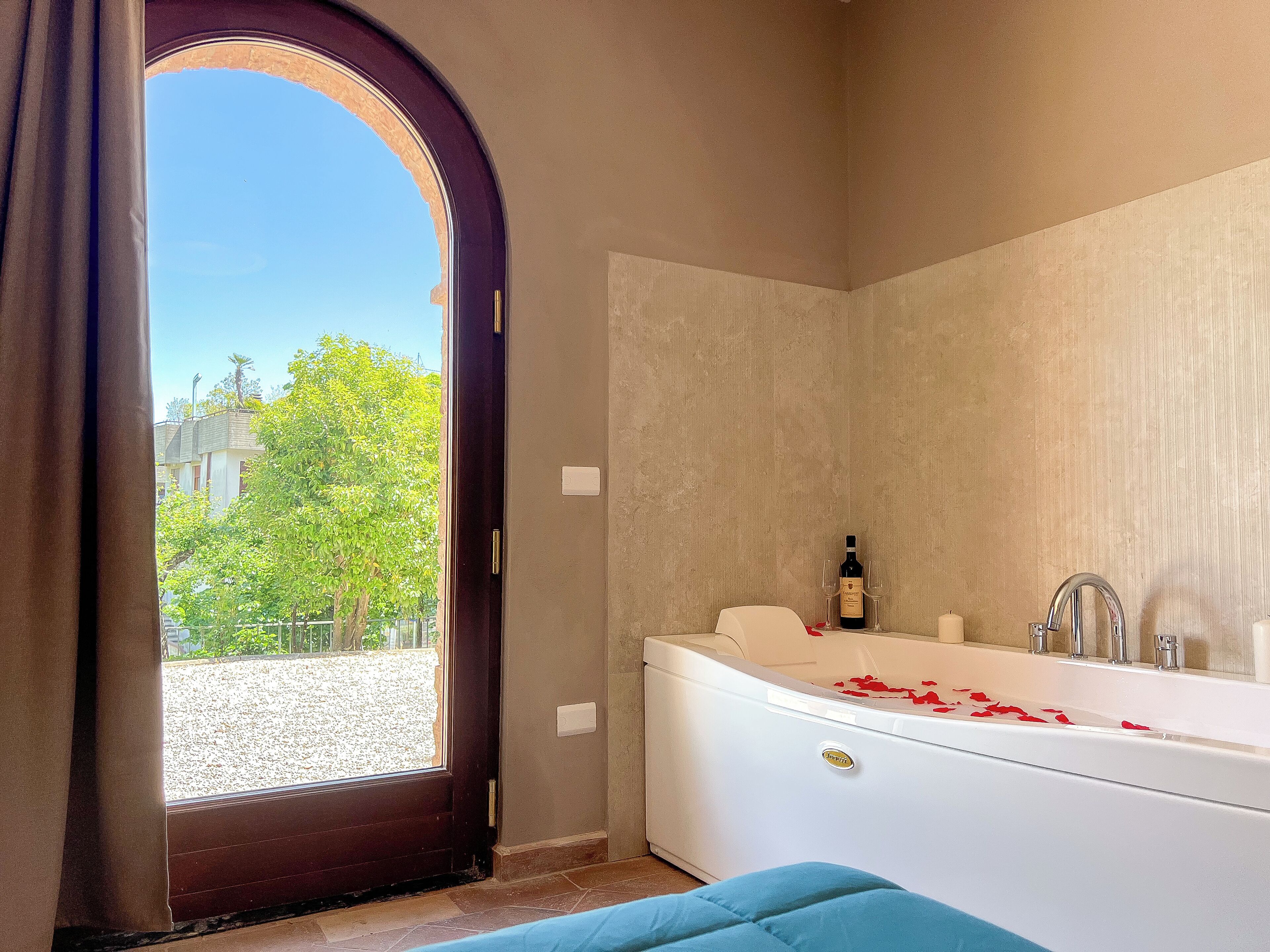 A bathroom with a bathtub, a shower, and a window.