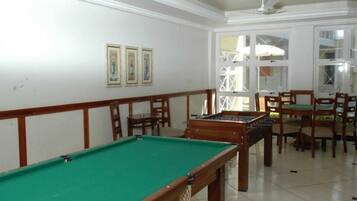 Enjoy a game of pool or foosball in this spacious room with a pool table and foosball table.