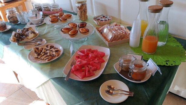 A breakfast buffet with various food items and condiments. - Agriturismo Arangea (Lequile)