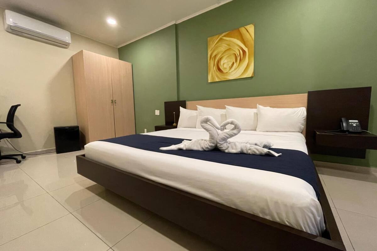 room, 1 king bed, no windows | 1 bedroom, desk, laptop workspace, iron/ironing board