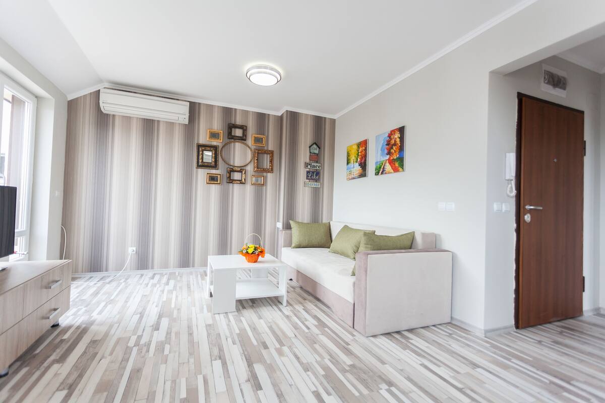 A modern living room with a sofa, coffee table, and decorative wall art.