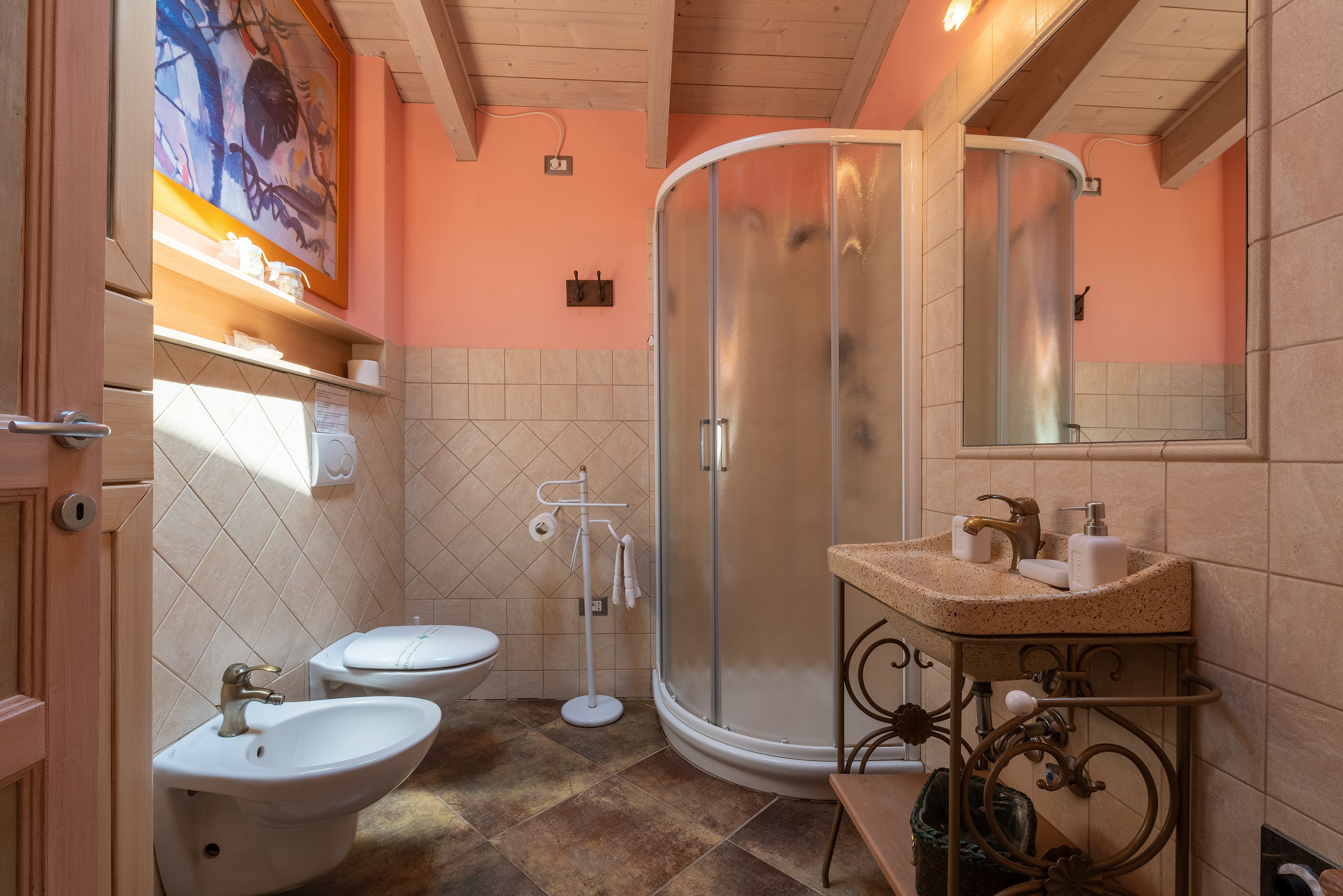 Un baño con dos lavamanos, un inodoro, una ducha y un espejo.