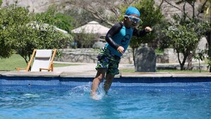 A person in a swimming pool with a blue cap and goggles, wearing a blue and green swimsuit. - Refugio de Santiago Ecolodge (Lunahuana)