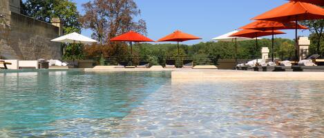 Seasonal outdoor pool, open 9:30 AM to 8 PM, pool umbrellas