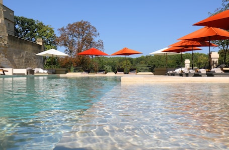 Seasonal outdoor pool, open 9:30 AM to 8 PM, pool umbrellas