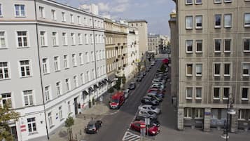 A street view with parked cars and buildings.