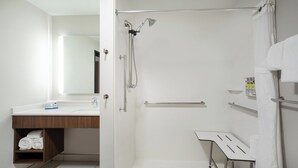 A modern bathroom with a shower, a sink, and a mirror. - Holiday Inn Express & Suites Sterling by IHG (Sterling)