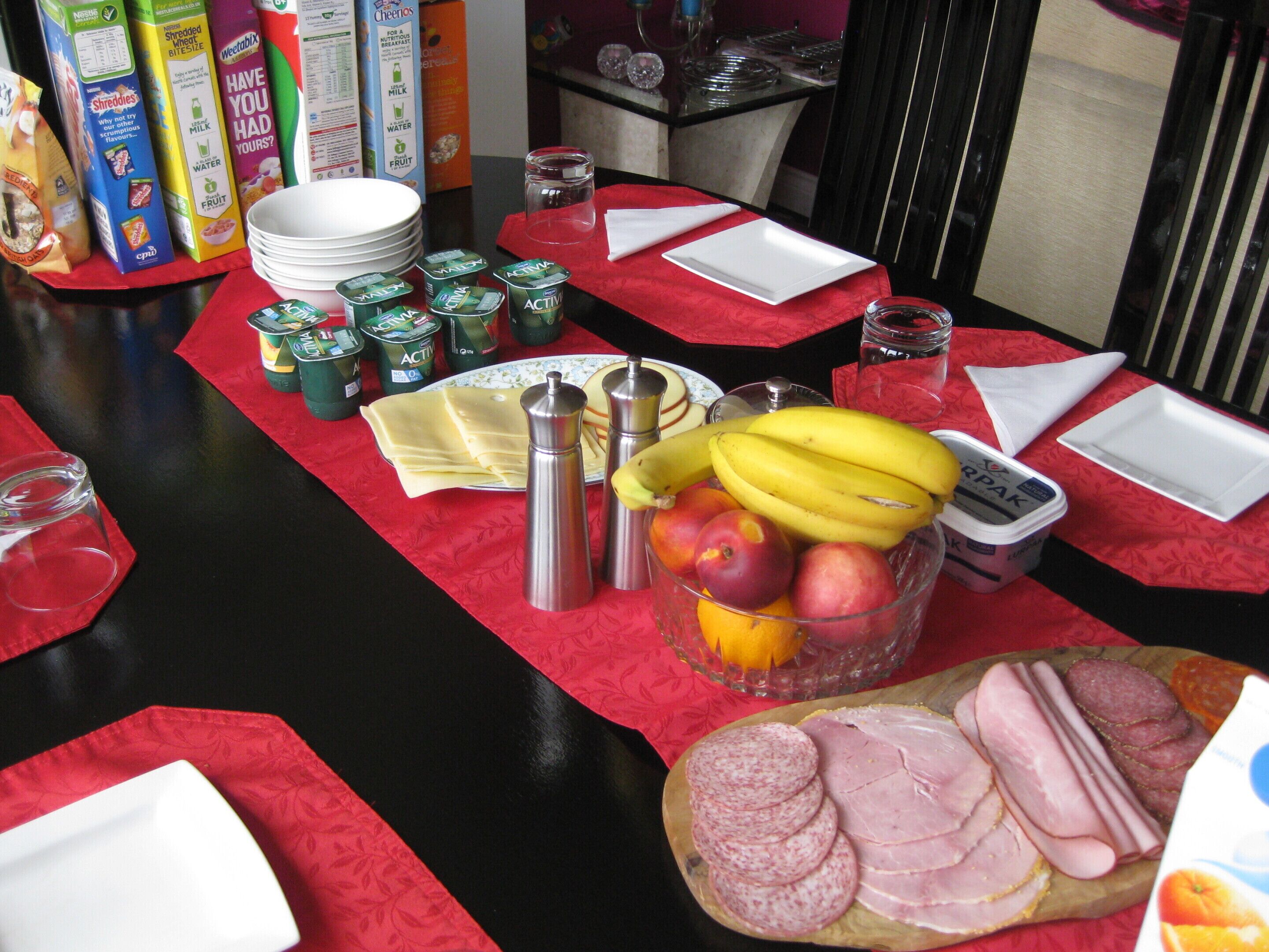 A breakfast buffet with various food items and condiments.