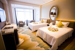 A hotel room with two beds, a sitting area with a table and chairs, a large mirror, and a view of the outdoors. - Shanghai Ship Hotel (Shanghai)