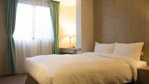 A neatly made bed with white linens in a hotel room. - The Koos Hotel Dahu (Taipei)