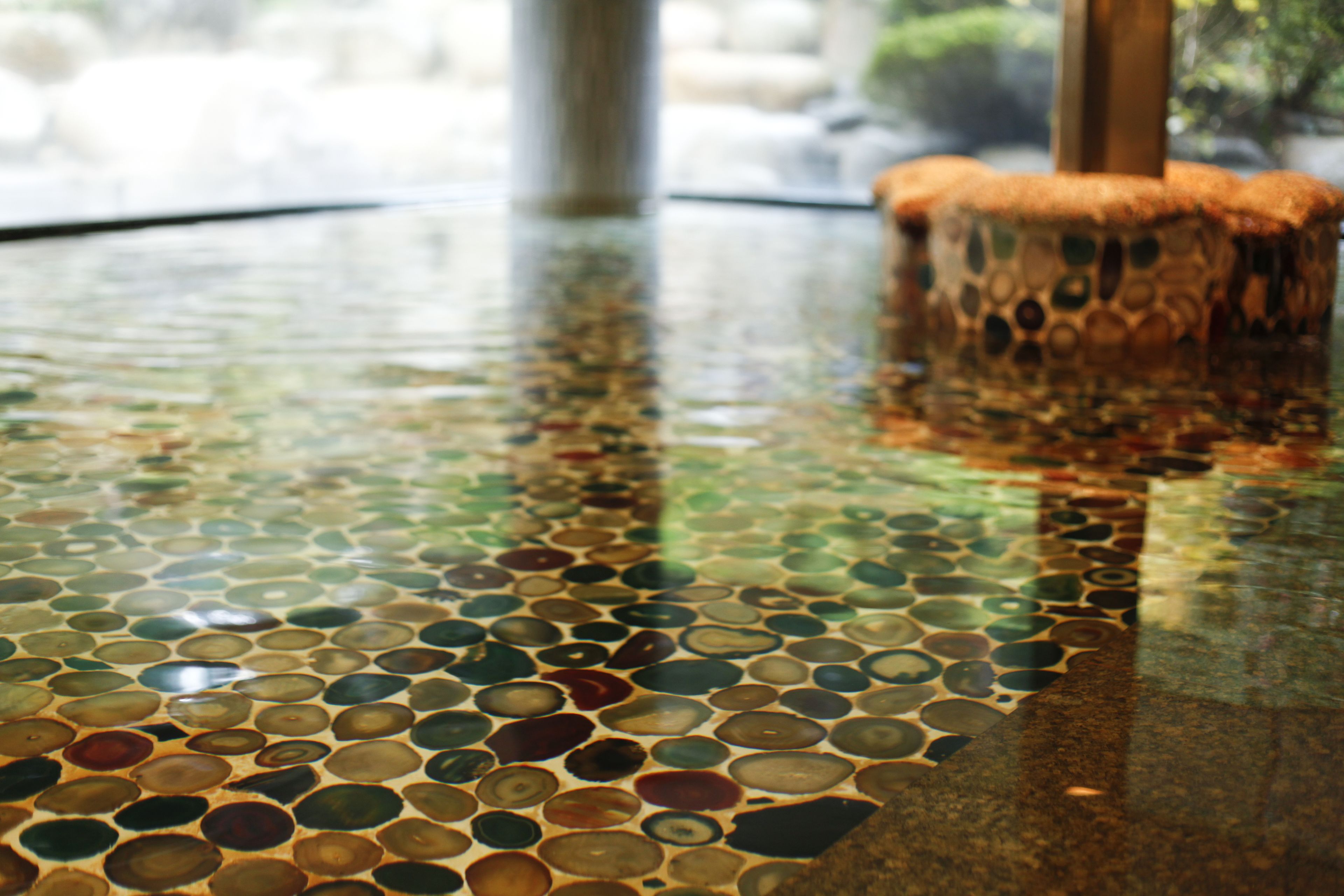 A mosaic-tiled floor with a central column.