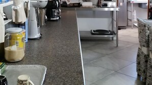 A kitchen with a granite countertop, wooden beams, and various appliances. - Myrtles Retreat (Still Bay)