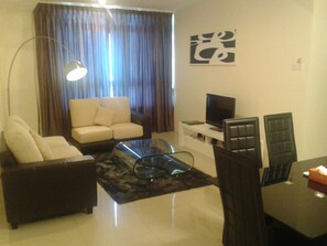 3 Bed Room | Living area | 32-inch LCD TV with digital channels, TV, DVD player - Taragon Apartment Services (Kuala Lumpur)