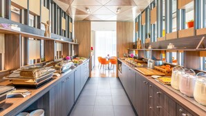 A modern kitchen with a central island, equipped with various appliances and utensils, flanked by cabinets and shelves. - Hotel Sophia by Tartuhotels (Tartu)