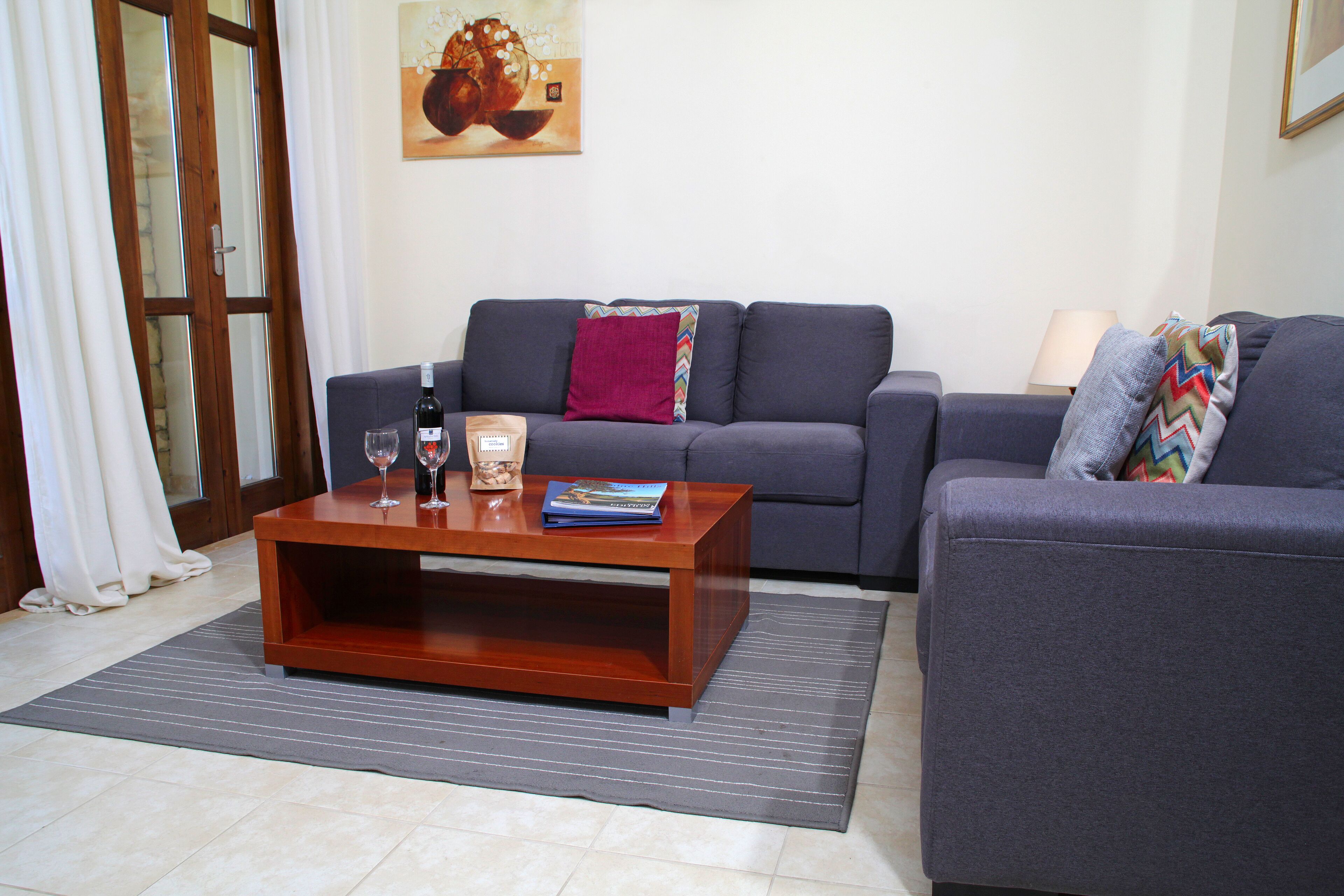A living room with a sofa, a coffee table, and a rug.