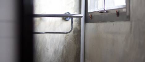 A metal handrail and a window with a metal latch.