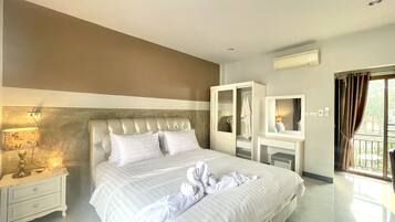 Relax in a spacious room with a large bed, bedside table, and wardrobe with mirror.