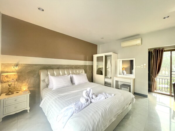 A modern hotel room with a large bed, a wardrobe, a vanity, and a balcony view. - Smaids Room (Lampang)