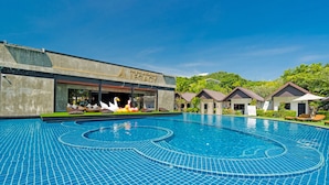 A swimming pool with a tiled design, a building labeled "Fiji Polynesian Legacy," and several small huts with roofs. - Phi Phi Andaman Legacy Resort (Ko Phi Phi)