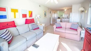 A living room with two sofas, a coffee table, and a ceiling fan. - Feelin' Beachy-7a 2 Bedroom Home by RedAwning (Supply)
