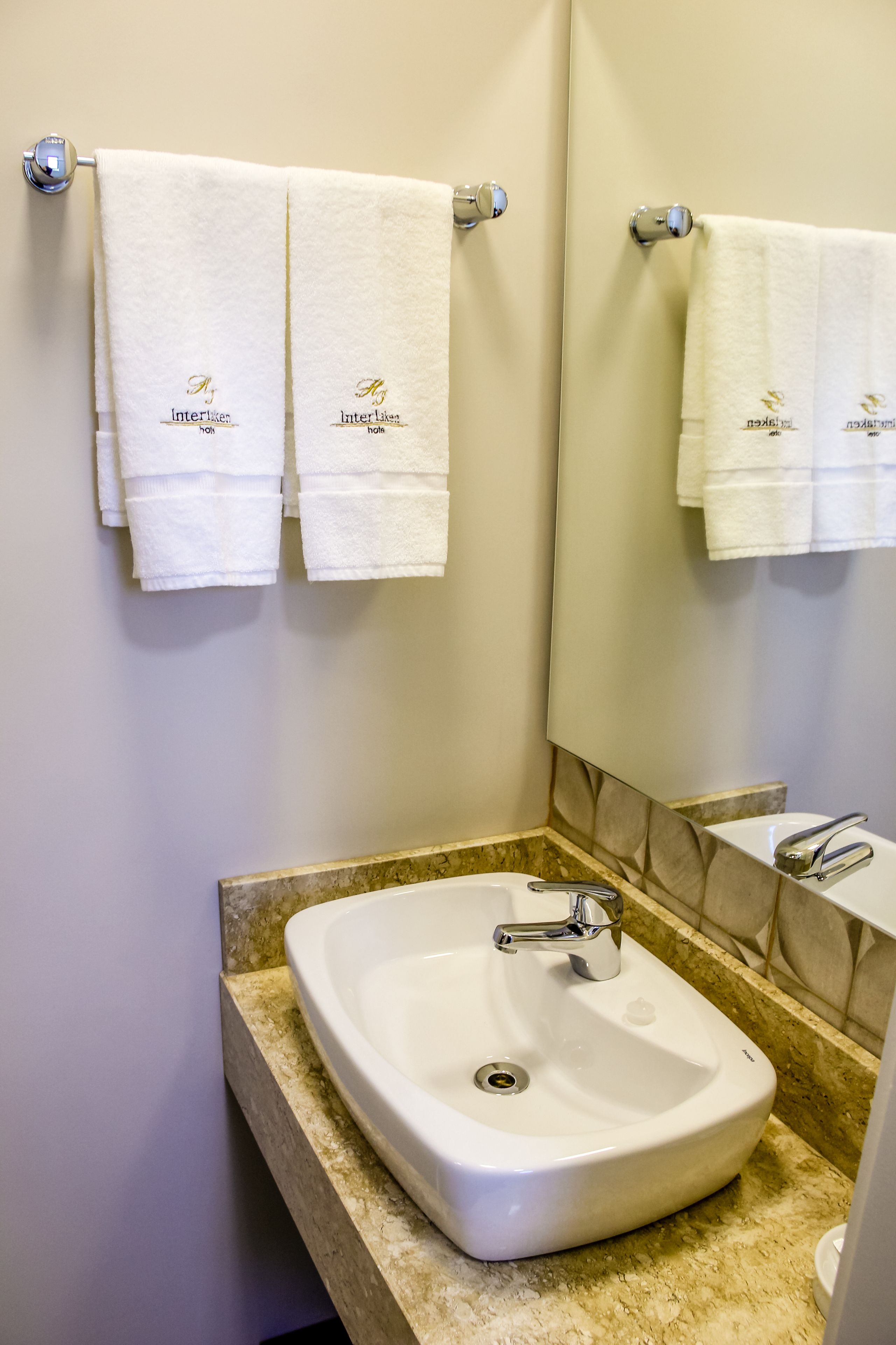 designer toiletries, hair dryer, towels