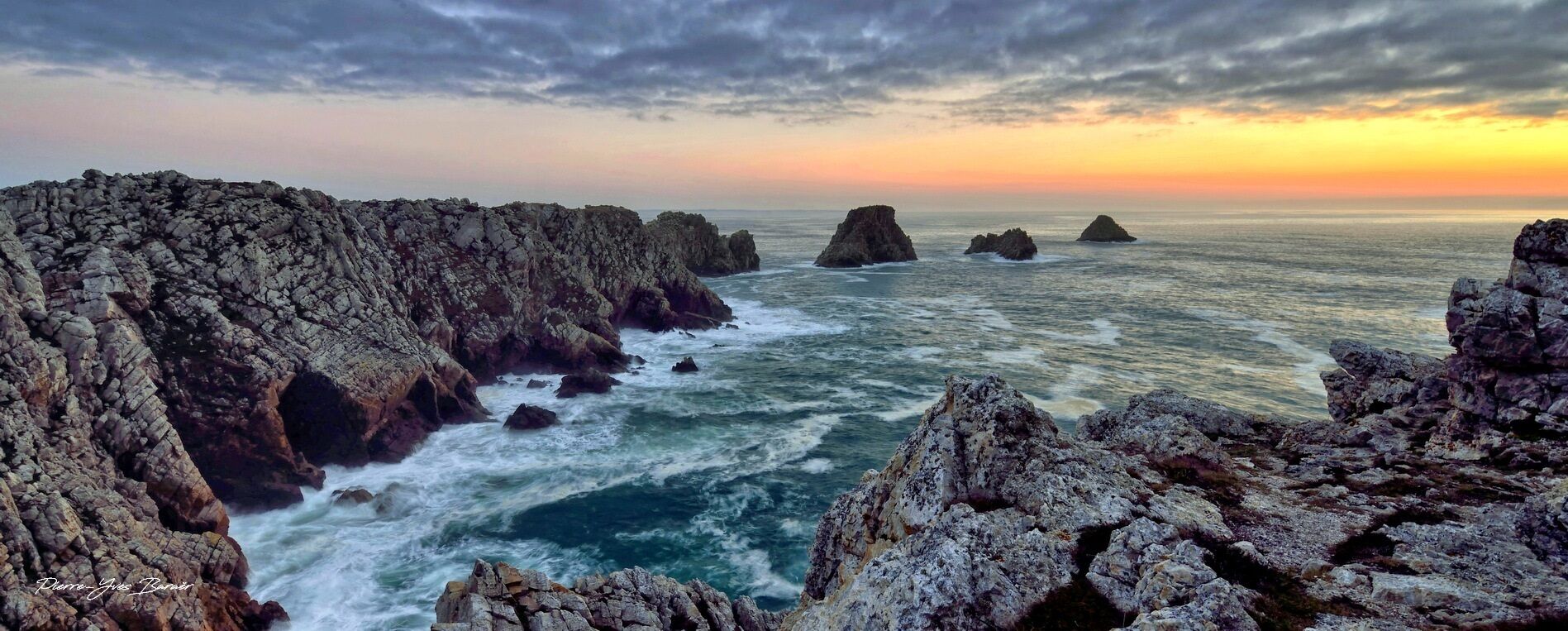 A coastal landscape with rocky cliffs and the ocean.
