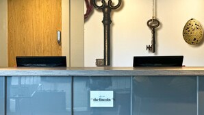 A reception desk with a wooden door, a vintage key, and a quail egg decoration. - The Lincoln Hotel (Lincoln)