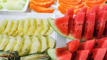A variety of sliced fruits including pineapple, watermelon, and orange.