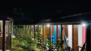 A courtyard with multiple rooms, some with doors visible, and a hammock in the center. - Pousada Aquarela (Porto Seguro)