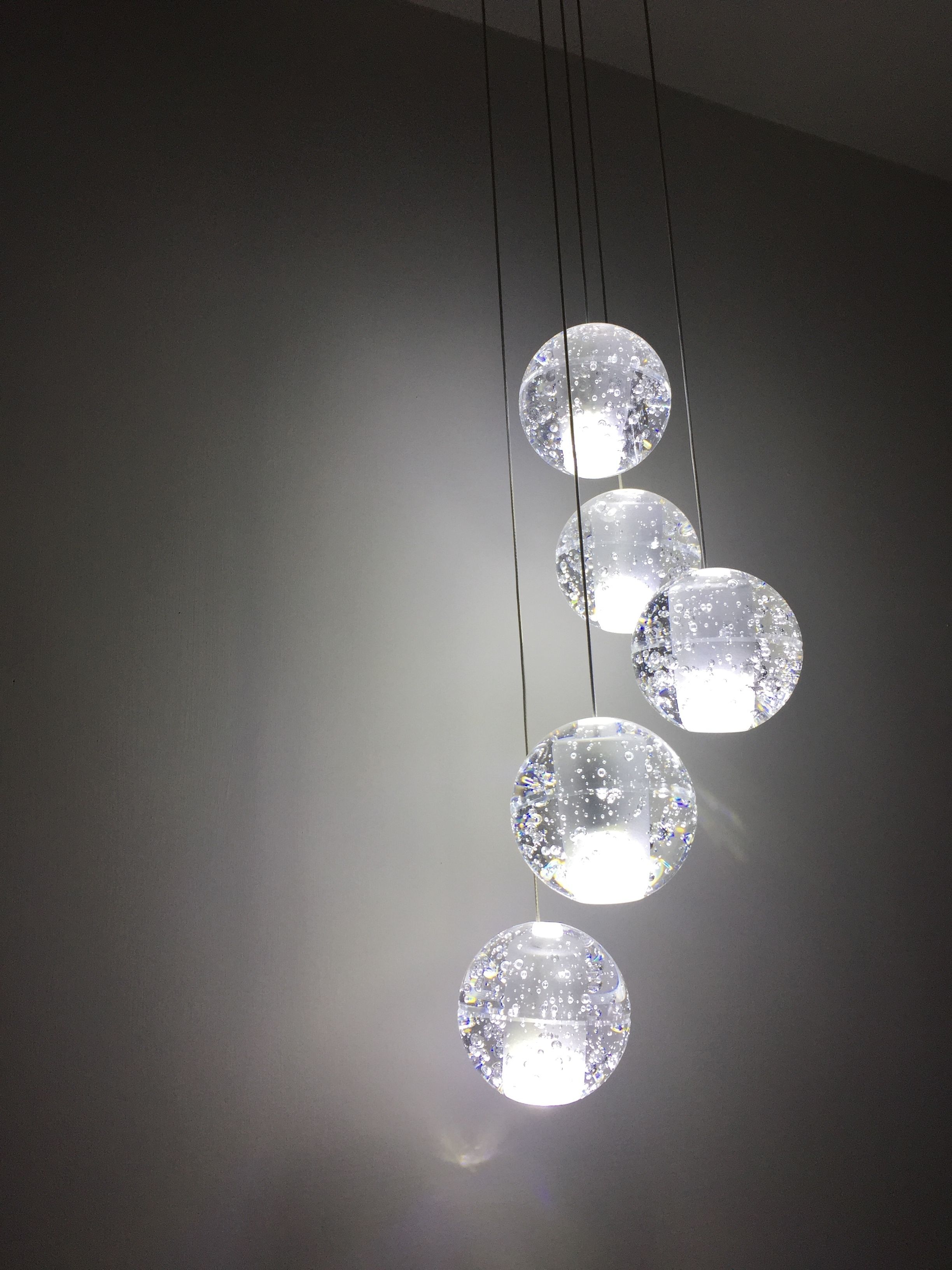 A chandelier with multiple spherical glass bulbs suspended from the ceiling.